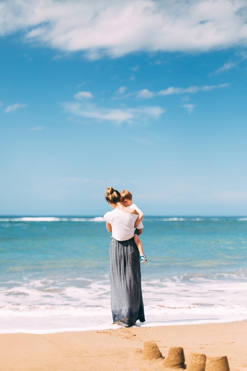 woman with toddler on seashore Spain